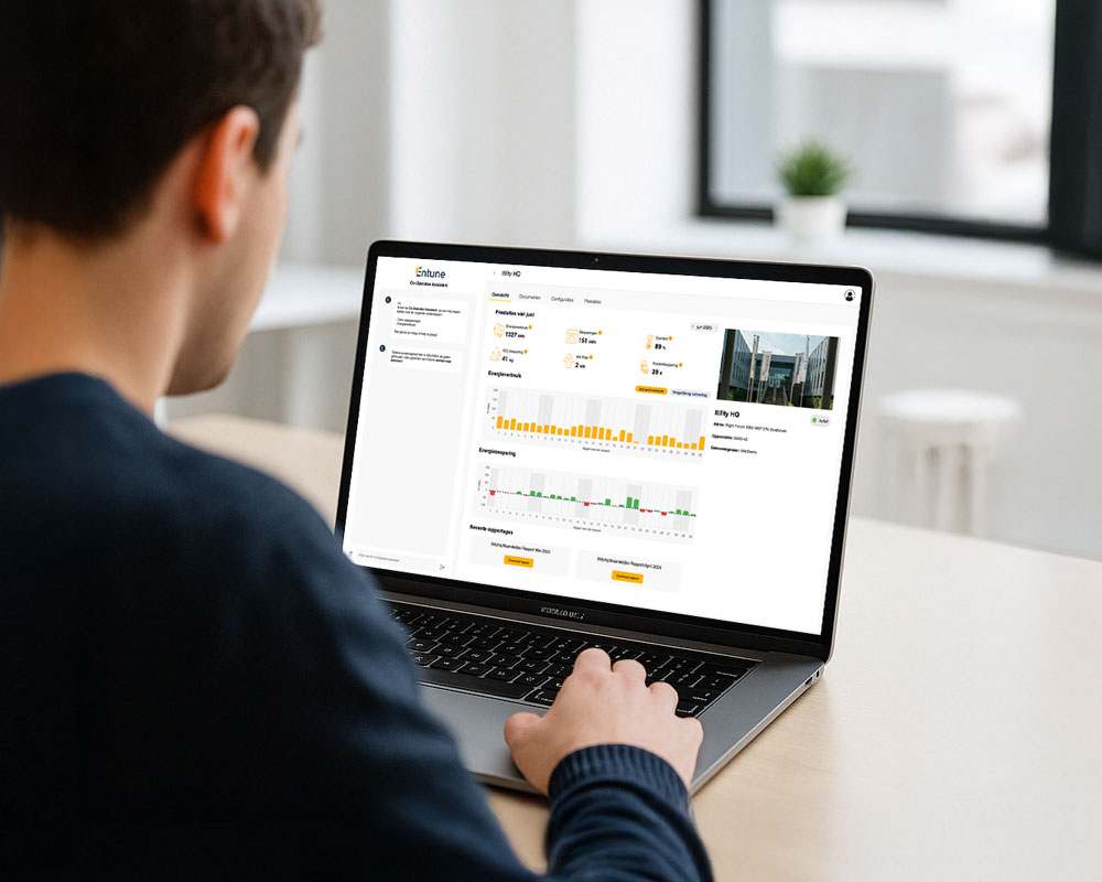 Person sitting at desk looking at a dashboard on a laptop